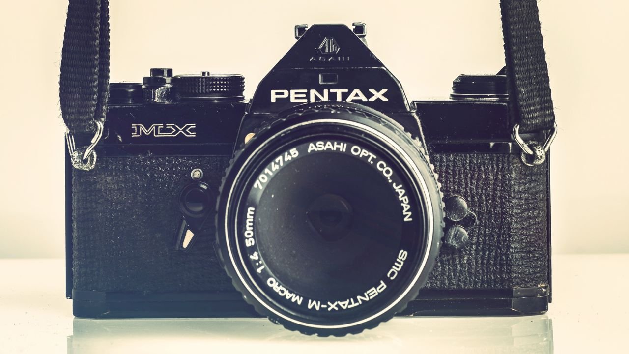 what is aug on pentax camera lens cap